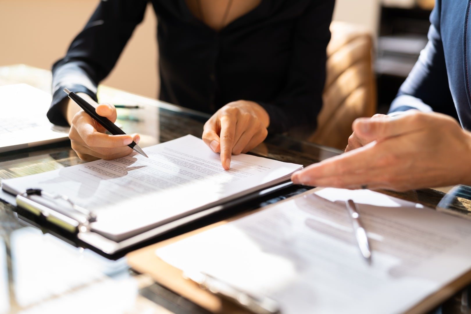 Attorney reviewing agreement terms with a client at a San Diego office